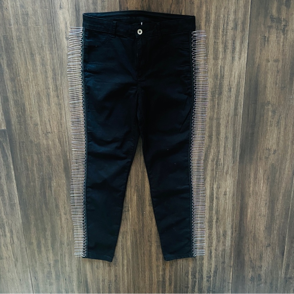 Stretchy black pants with ball chain fringe.